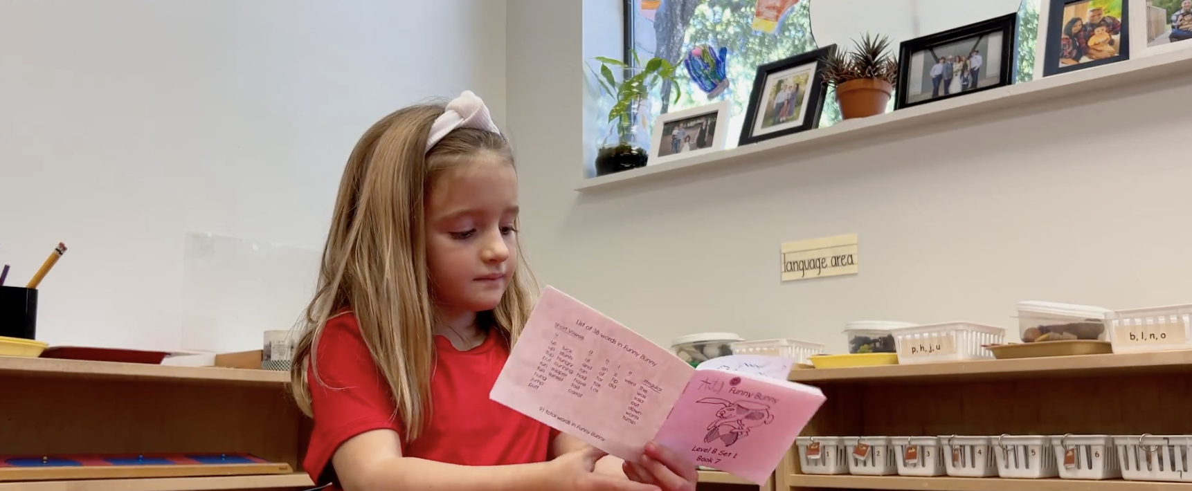 A Preschooler reading a book in one of our classrooms. She is going through the process of reading the books for preschoolers.